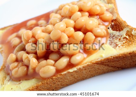 A plate with baked beans on toast seen close-up