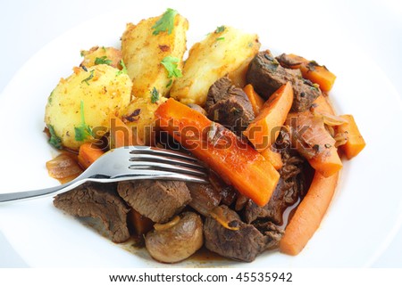 French-style beef and carrot stew with herbs, served with sauteed potatoes garnished with parsley