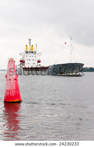 Red float and empty ship in overcast day