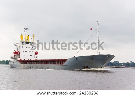 Empty cargo ship under pale gray sky