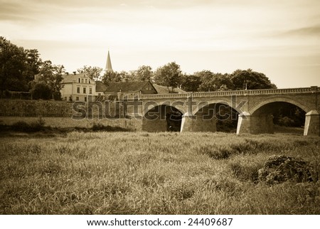 Ancient bridge over river Venta in Kuldiga, Latvia. Sepia