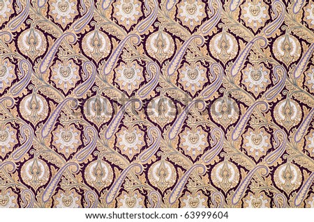 Brown background textile with arabesque style ornament