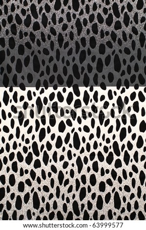Textile background with split black and white cow pattern