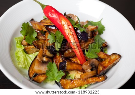 Salad from roasted eggplants, mushrooms, soy sauce, oyster sauce, cilantro and garlic