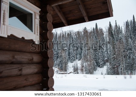 Winter house in forest. Clean air, rest and relaxation. Unity with nature. View from the porch to the forest