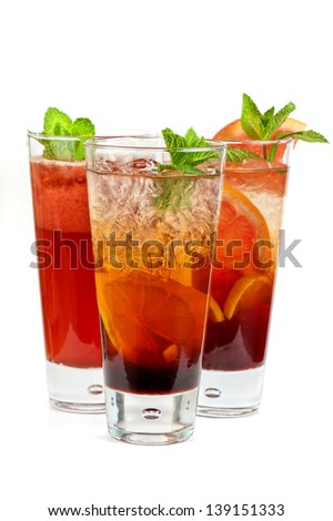 Set of fresh cold tea with fruits, berries and ice on white