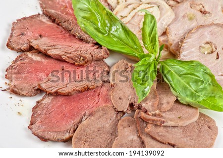 Closeup meat cuts with greens