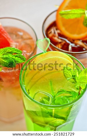 Set of fresh cold tea with fruits, berries and ice on white