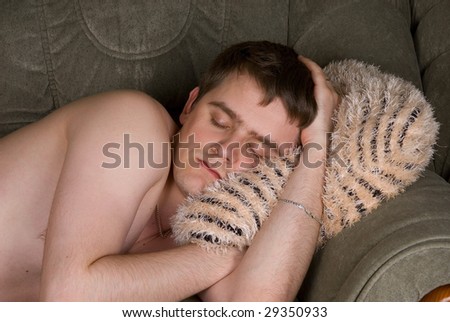A man sleeps on the sofa