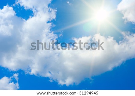 Sun rays against a blue summer sky