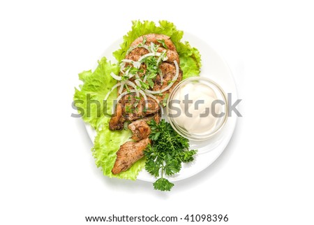 Roast meat with sauce and vegetables isolated on white background