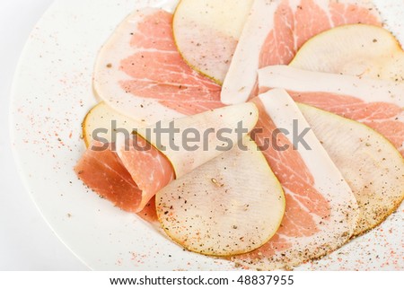 Sliced bacon with sliced pear decorated closeup