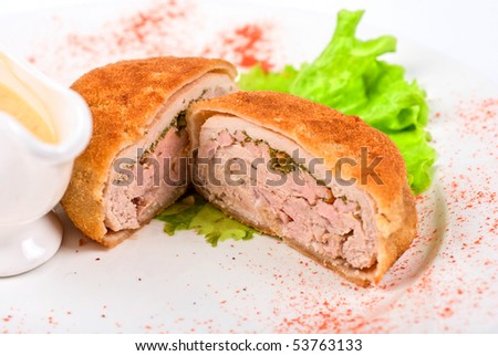 Beef cutlet closeup stuffed with bacon on white plate