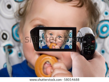 stock photo pretty baby boy laughing portrait with bread ring recording at