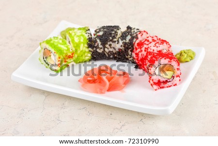 Sushi rolls made of fish avocado and different flying fish roe (tobiko caviar)