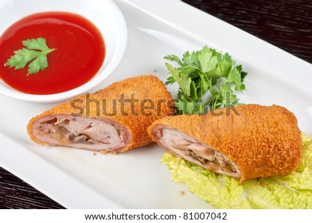 Closeup of rolls from pork meat, champignon mushroom, cheese and sauce