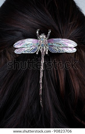 Woman coiffure with dragonfly hairpin