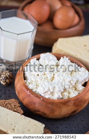 still life with dairy products as milk, cheese cottage cheese eggs and bread
