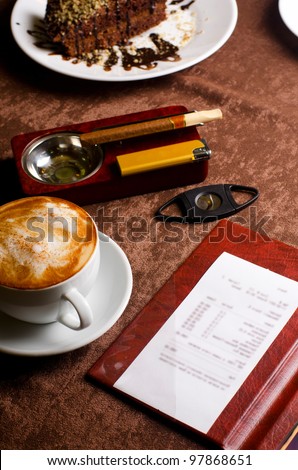 check, ashtray, cigar, lighter and coffee at restaurant table