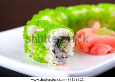 Sushi rolls made of salmon, avocado, flying fish roe
