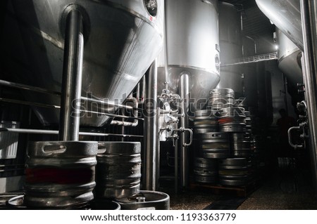 The interior of the brewery. Modern beer factory. Rows of steel stainless tanks for beer fermentation and maturation. Shop brewery. Geometry of plant.
