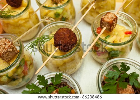 Glass vessels of a cold buffet with mixed food