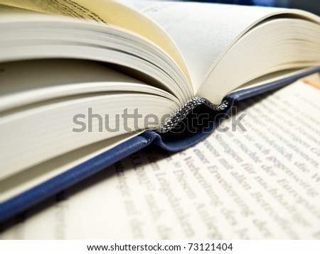 An open book on a sheet of paper