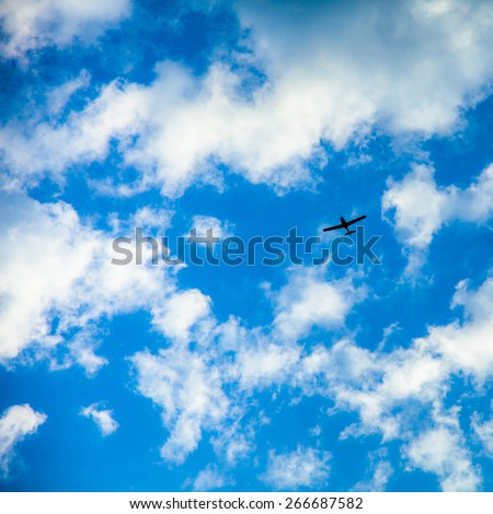 Small plan on clouds background