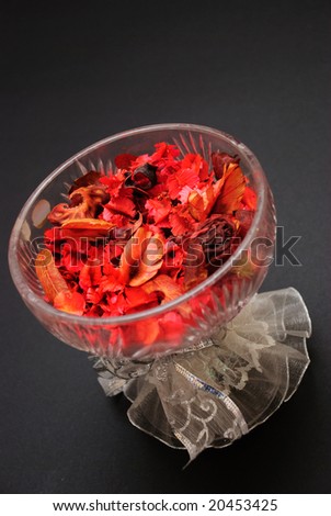 Bowl of red potpourri in crystal glass