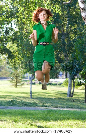 Young beautiful woman jumps with happiness