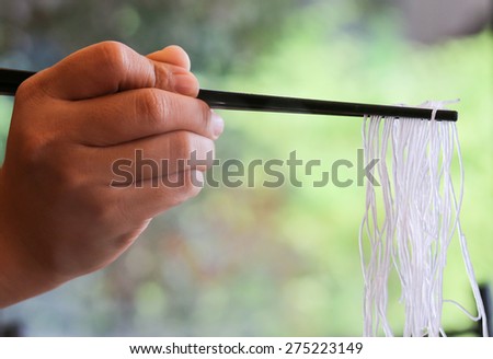 hand pick chopstick eating noodle.