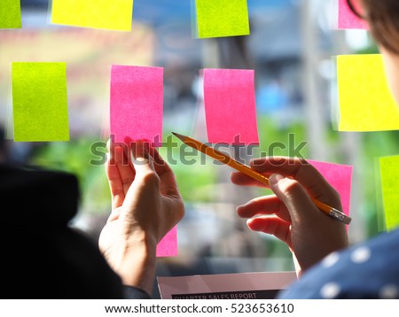 Sticky note paper reminder schedule board. Business people meeting and use post it notes to share idea on sticky note. Discussing - business, teamwork, brainstorming concept vintage tone