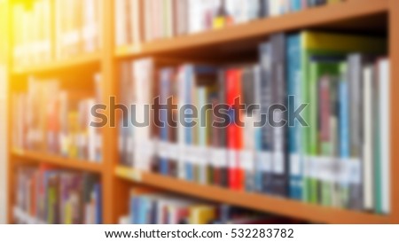 Books on bookshelf in library room, abstract blur de focused background