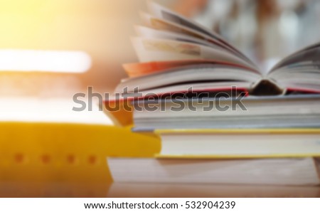 Open book on wood desk in the library room with blurred focus for background, education back to school concept