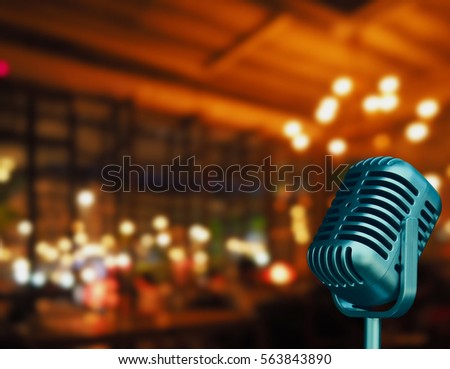 Vintage micro phone with blurred night light in restaurant or night club background and soft focus