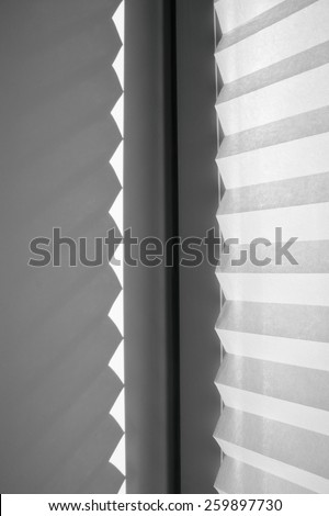 shadow in the shape of triangles from paper blinds on the wall, streaks of light and shadow, abstract background