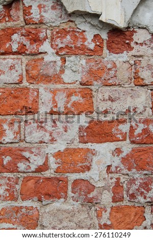 a thick layer of plaster on the surface of a wall of red brick, texture