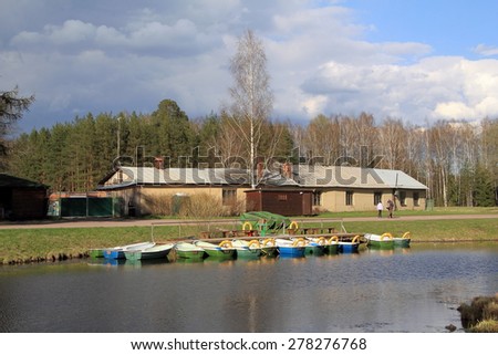 the boat station: river, boats on the shore, buildings