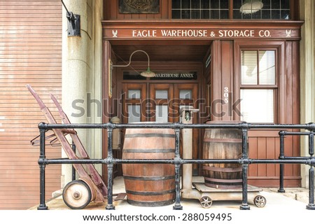 OSAKA, JAPAN - JUN 2, 2015 : Photo of a building called Eagle Warehouse & Storage Co. with beer barrel in the front that located inside Universal Studio, Osaka, Japan. Replicated in Cowboy Theme.