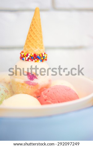 Birthday Ice Cream Set with Colorful Sprinkles Cone on Top and Dry Ice on the Bottom, Selective Focus, Blur Brick Background, Wallpaper. Birthday Celebration Concept. Sweet Pastel Theme.