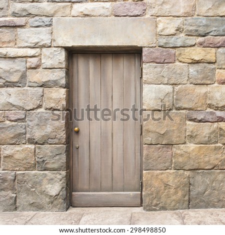 Vintage Wooden Door in the Middle in Rock Wall