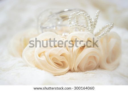 Soft Focus of Handmade Rose Ribbon Hair-Clip in Creamy Beige, Isolated on Lace Cloth Fabric [Vivid Bright Collection]