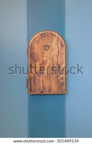 Electric Socket on the Blue Wall, replica a small wooden door from \