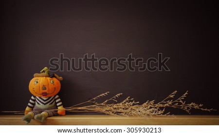 Pumpkin Plush Doll with Chalk Black Board, for Halloween Background, Wallpaper, toned photo [Vintage Warm Collection]