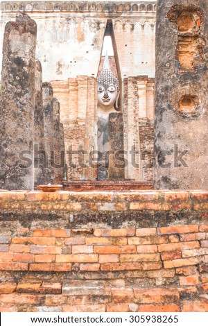 Ancient Great Buddha Statue Behind the Wall, Sukhothai Style Architecture. At \