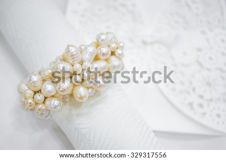 Silver Plated Napkin Ring Holder with Pearl and Rhinestone Flower Charm Ideal Ornament, Decoration on wedding party table, Abstract Invitation Card on the Background, Selective Focus