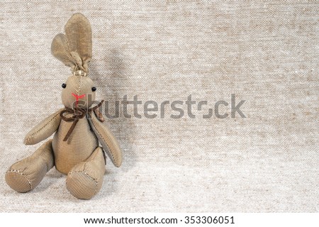 Brown Rabbit Plush Doll isolated on Brown Background for Wallpaper.