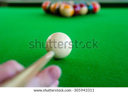 Placement of billiard balls on the table before the game. Focus on the white ball