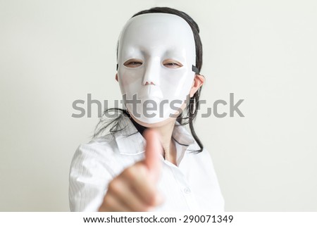 Asian woman wearing white mask thumbs up