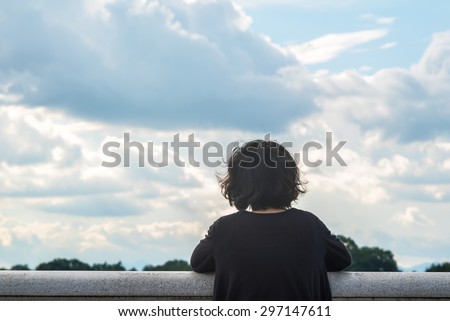 Asian woman looking at sky and lake